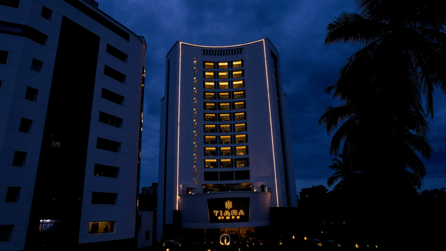 An evening view of Tiara by MPS facade with lit windows under a dark cloudy sky.