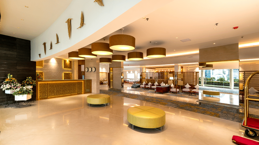 A bright hotel lounge area showcasing circular seating stools and a polished floor surface at Tiara by MPS.