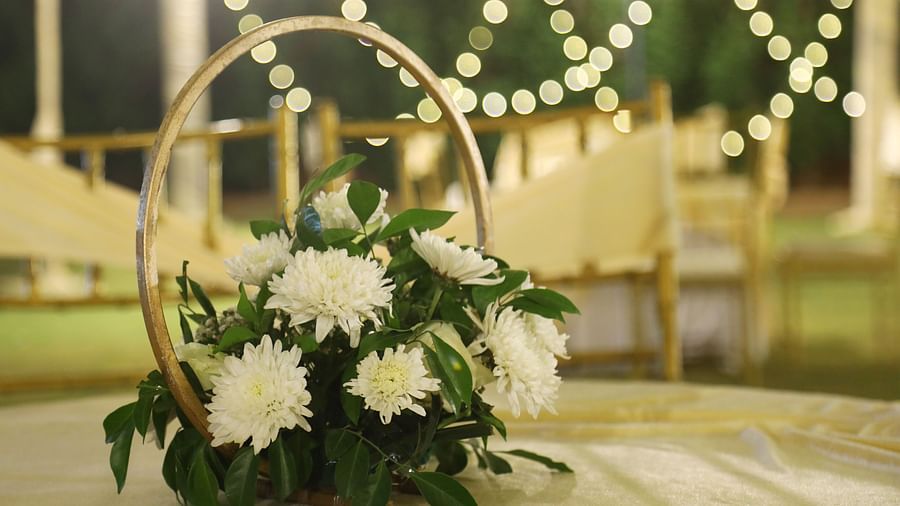 White floral arrangement with circular frame and string lights in the background at Tisya Farms, Gurgaon.