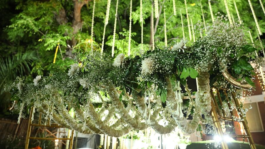Overhead floral installation with dense greenery and hanging decor at Tisya Farms, Gurgaon.