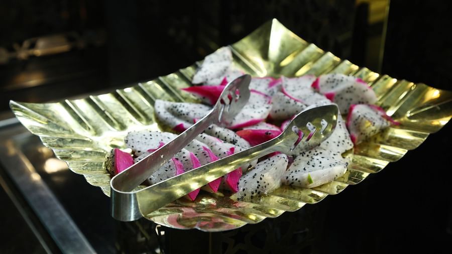 Plate with sliced dragon fruit and radish served on a leaf plate at Tisya Farms, Gurgaon.