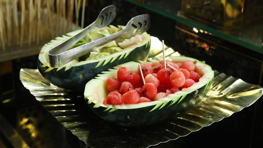 Plate of sliced watermelon served on a leaf-patterned plate at Tisya Farms, Gurgaon.