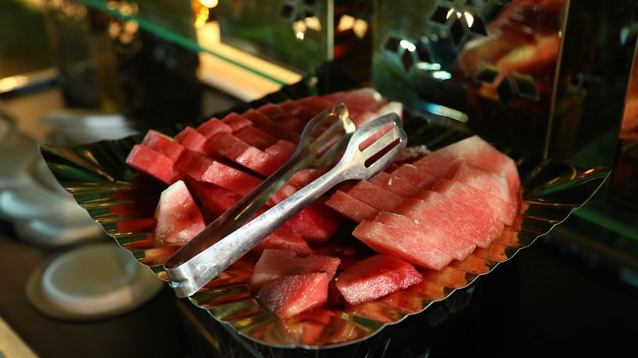 Watermelon slices arranged on a leaf plate at a food counter in Tisya Farms, Gurgaon.