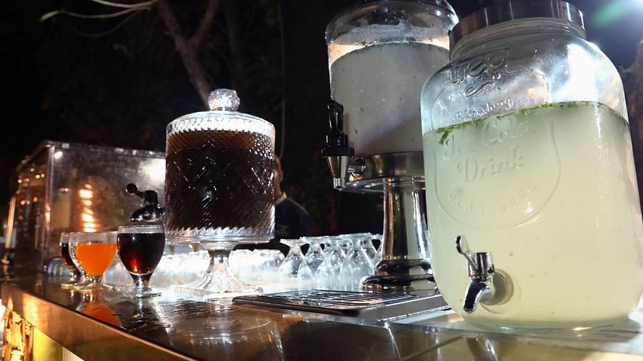 Drink dispensers with ice-filled containers of juice and water at a night event in Tisya Farms, Gurgaon.