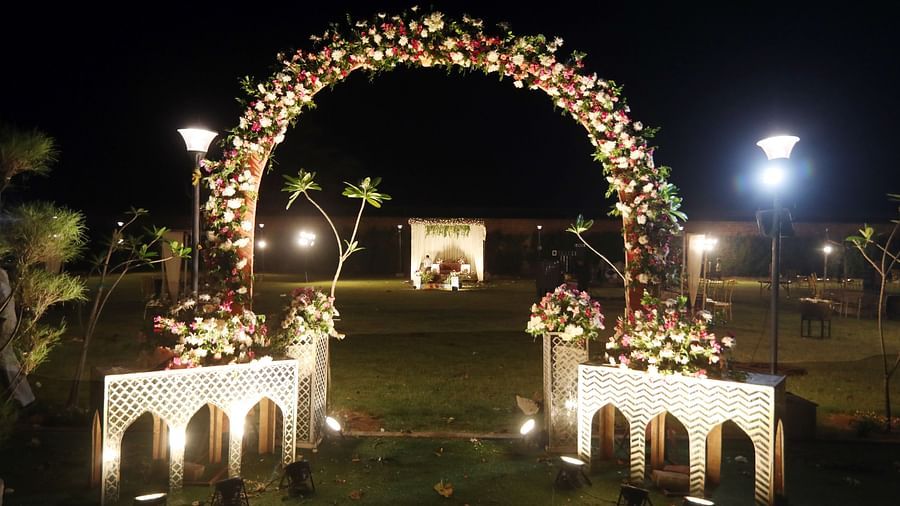 Floral archway with pathway lighting set up for an evening event at Tisya Farms, Gurgaon.