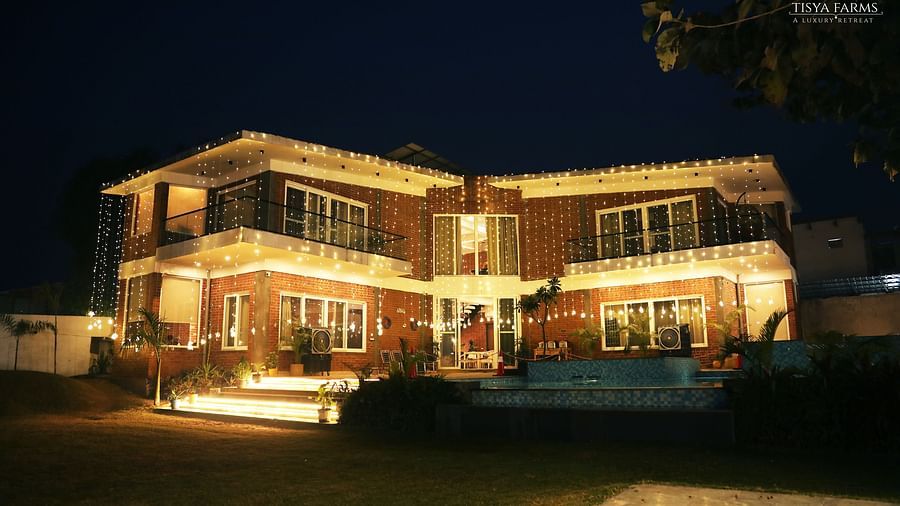 Night view of Tisya Farms decorated with warm yellow lights.