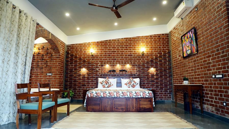 A spacious suite featuring a bed and a ceiling fan  at Tisya Farms, Gurgaon.