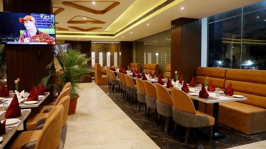 Spacious restaurant at Town Square Suites with modern interiors and ample seating arrangement