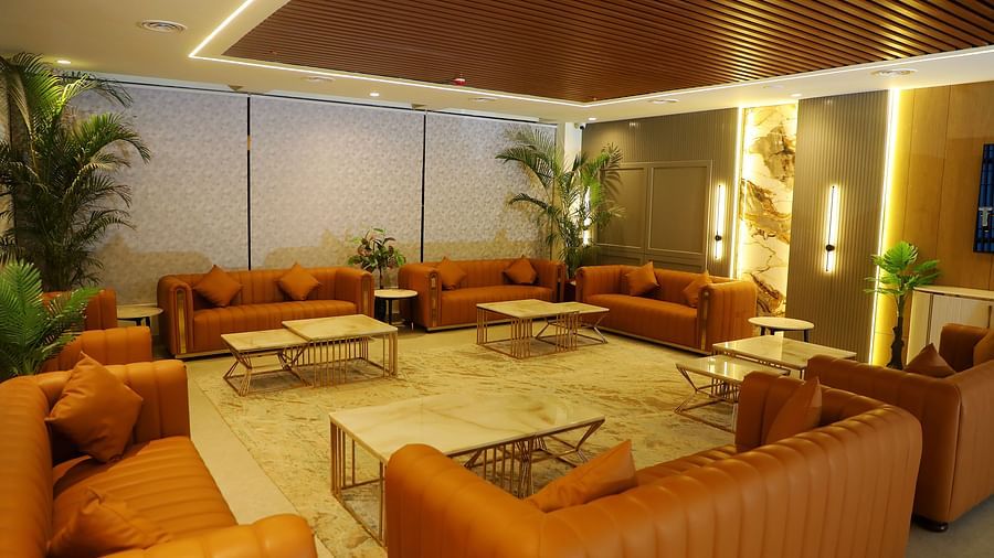Elegant guest lounge at Town Square Suites with plush sofas and warm lighting