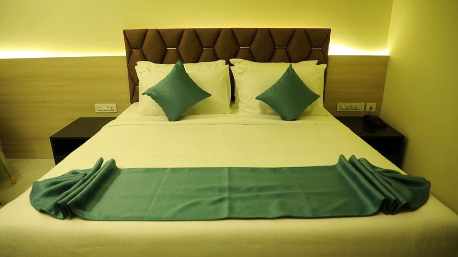 King-size luxury bedroom at Town Square Suites with contemporary decor and plush bedding
