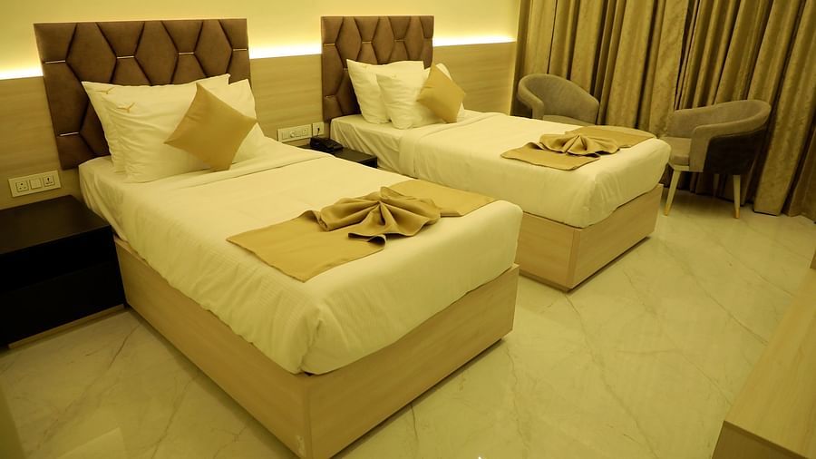 Twin bed deluxe room at Town Square Suites with elegant furnishings and cozy linens