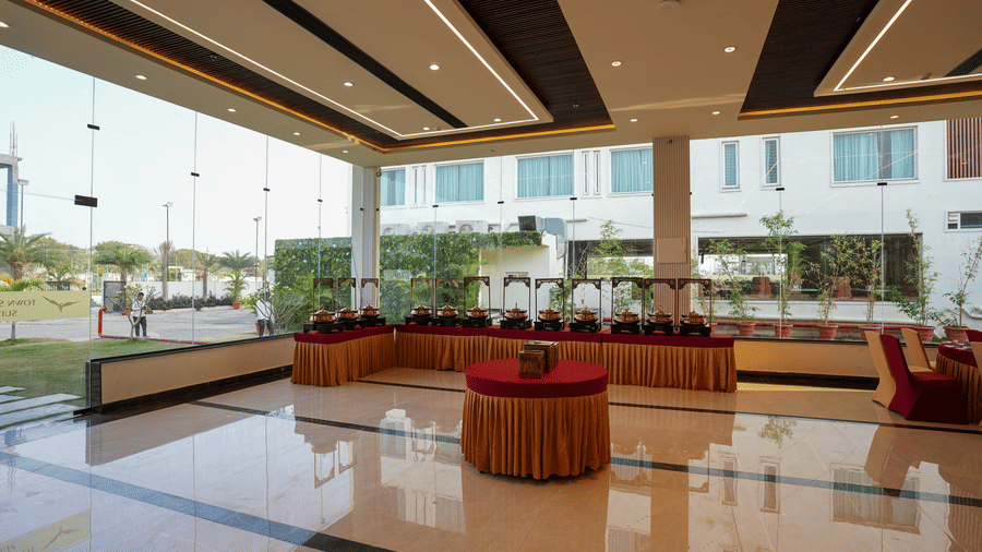 Open-air banquet terrace with red seating and panoramic views at Town Square Suites