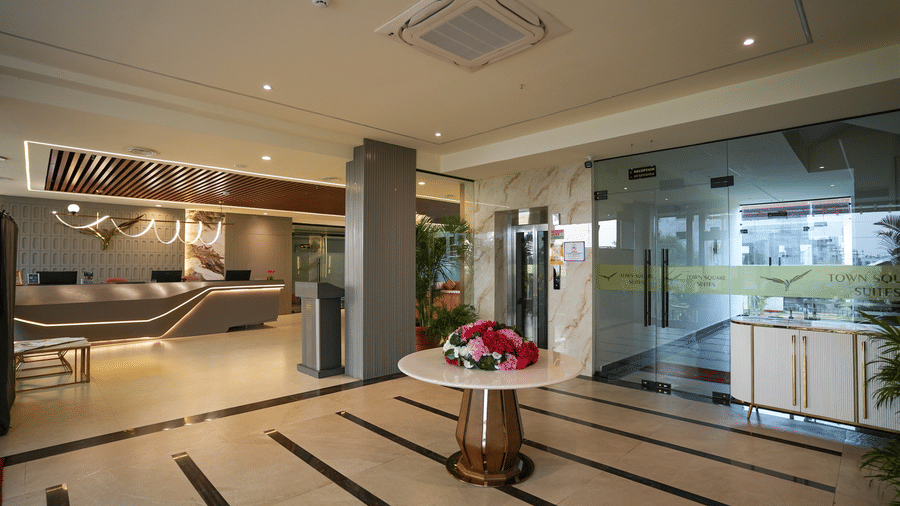 Lobby at Town Square Suites with polished floors, reception area, and elegant minimalist decor.