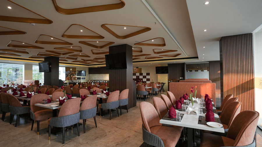 Restaurant interior at Town Square Suites with elegant seating, warm lighting, and stylish decor.