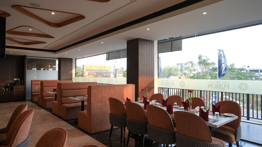 Restaurant seating at Town Square Suites with city view, large windows, and neatly arranged tables.