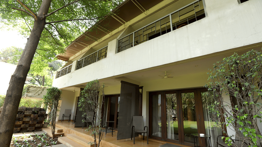 Exterior of the facade at Trance Sunderban Resort featuring a balcony with glass railings and a ground-floor terrace.