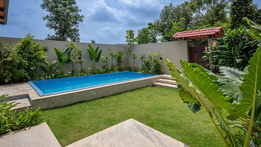 Lush green lawn beside private pool at Ananta Pool Villa – 5-Bedroom Pool Villa, Trance Veechika Resort, Vikarabad.