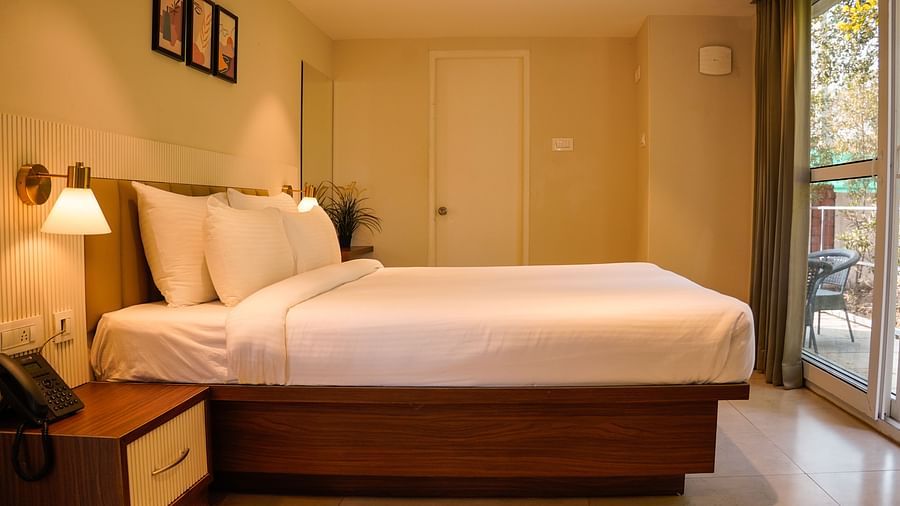 BedrpooAn image of Kalpa room with king size bed, side tables, and decorative items - Trance Veechika Resortm 2