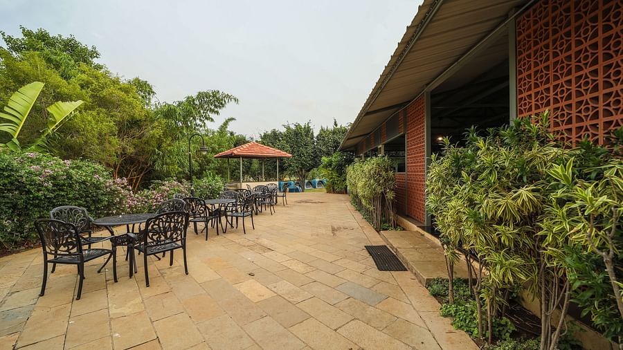 An image of outdoor seating arrangement of the dining area - Trance Veechika Resort, Vikarabad