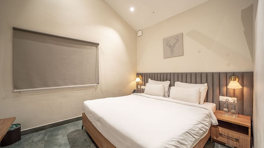 An image of a room with king size bed, bed side tables, lamps - Trance Veechika Resort, Vikarabad