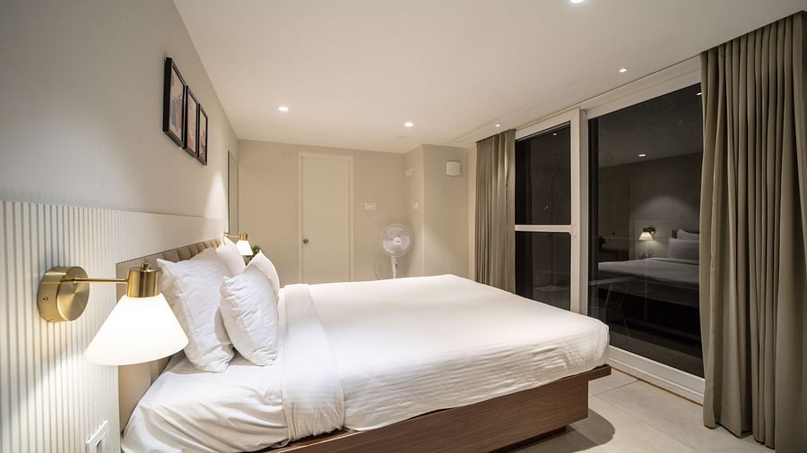 An image of a room with king size bed, bed side tables, lamps - Trance Veechika Resort, Vikarabad