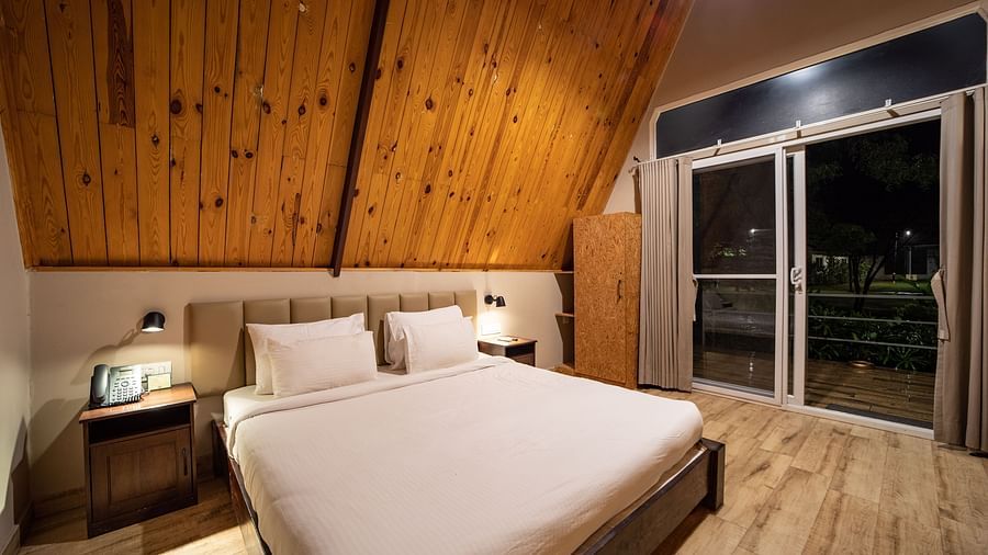 An image of a room with king size bed, bed side tables, cupboard - Trance Veechika Resort, Vikarabad
