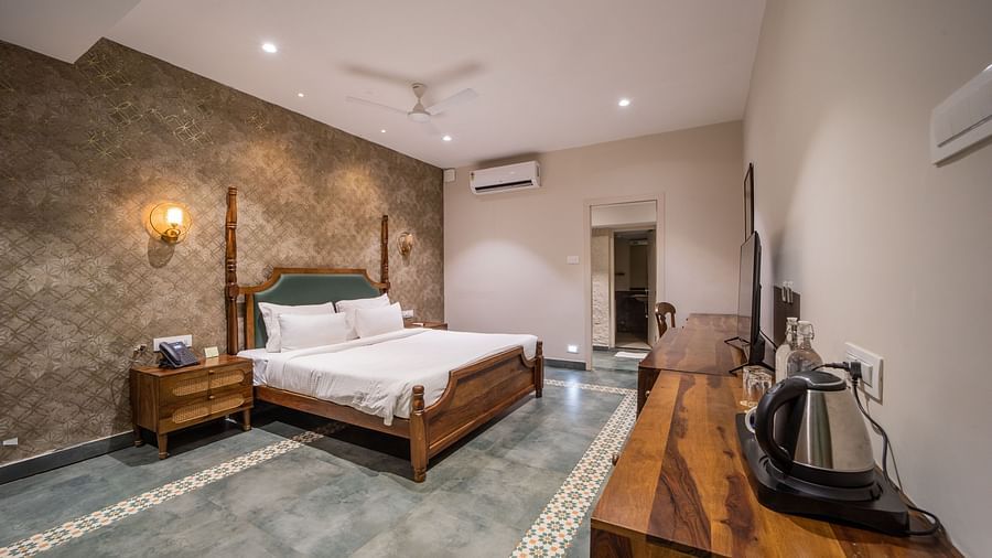 An image of a room with king size bed, TV, bed side table - Trance Veechika Resort, Vikarabad