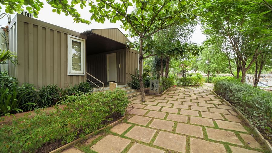 A facade image of a pathway featuring a room on the left side of it with greenery around - Trance Veechika Resort, Vikarabad