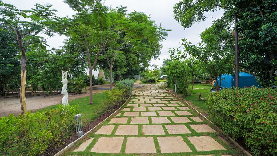 A facade image of pathway with greenery on both sides - Trance Veechika Resort, Vikarabad