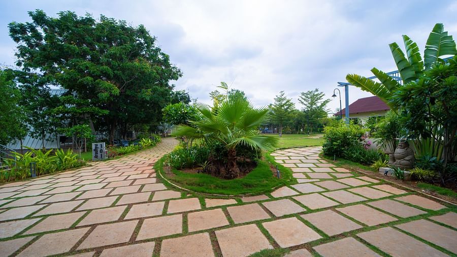 A facade image of pathway with greenery on both sides - Trance Veechika Resort, Vikarabad