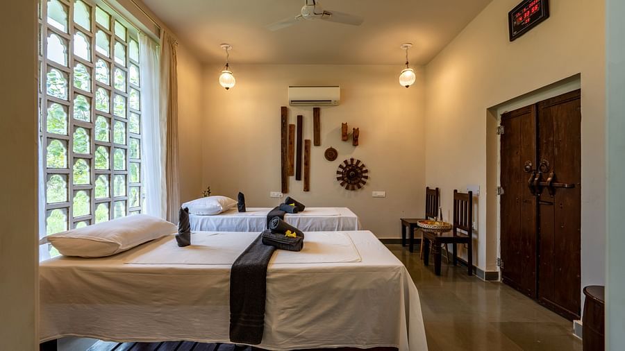 A side angle of the spa with ambient lighting and two beds - Utsav Camp