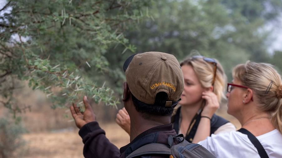 An image of two women with a tourist guide - Utsav Camp Sariska