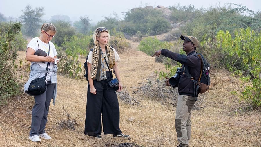 An image of two women with a tourist guide - Utsav Camp Sariska
