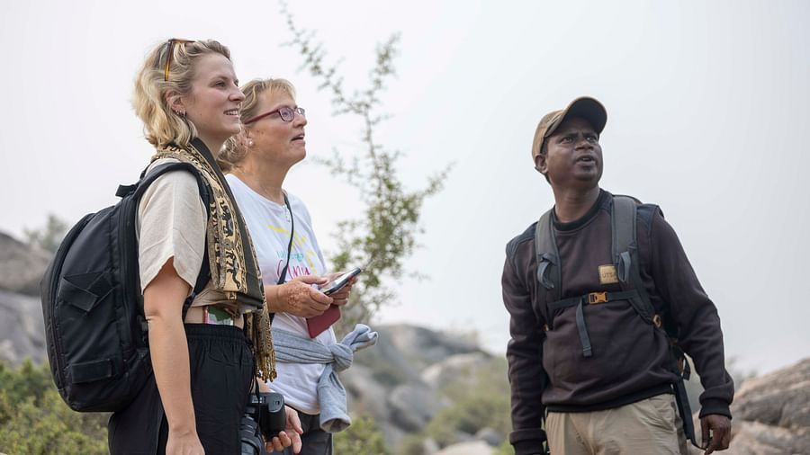 An image of two women with a tourist guide - Utsav Camp Sariska