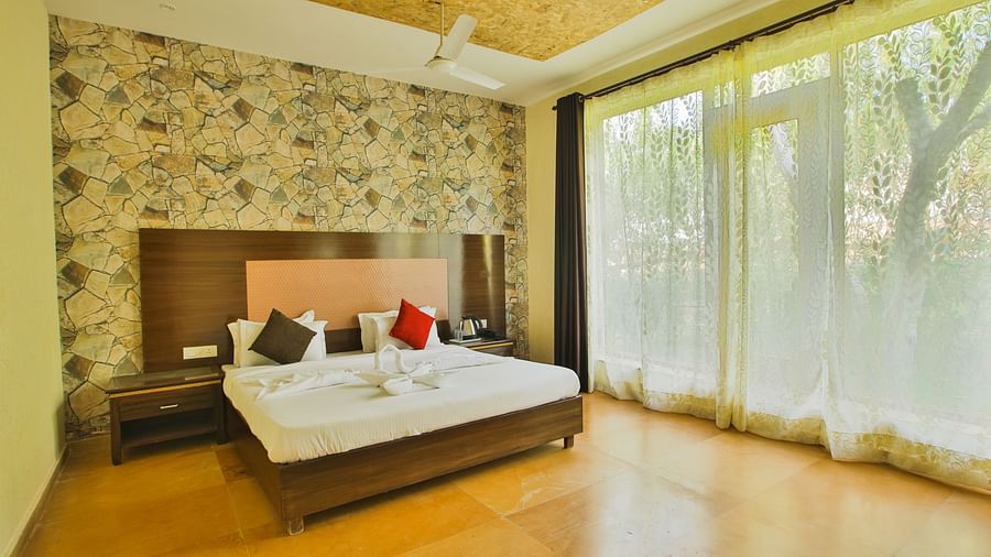 A bright room with floor-to-ceiling windows, warm wooden accents, and elegant decor at Valley by Grassfield.