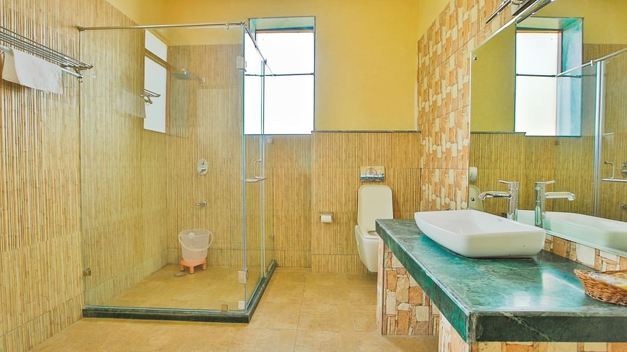 A washroom with a sink and a separate shower area at Valley by Grassfield.