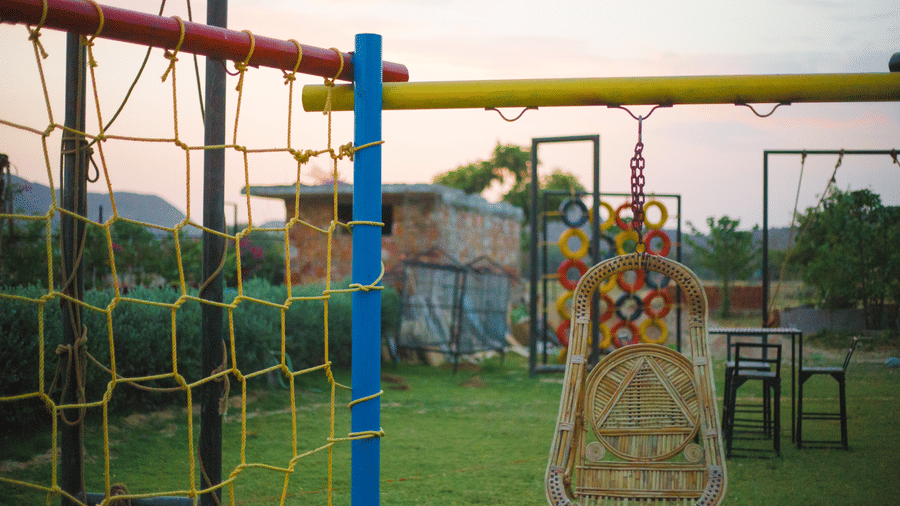 Play area with swings and climbing nets at Valley by Grassfield, a family resort in Jaipur.