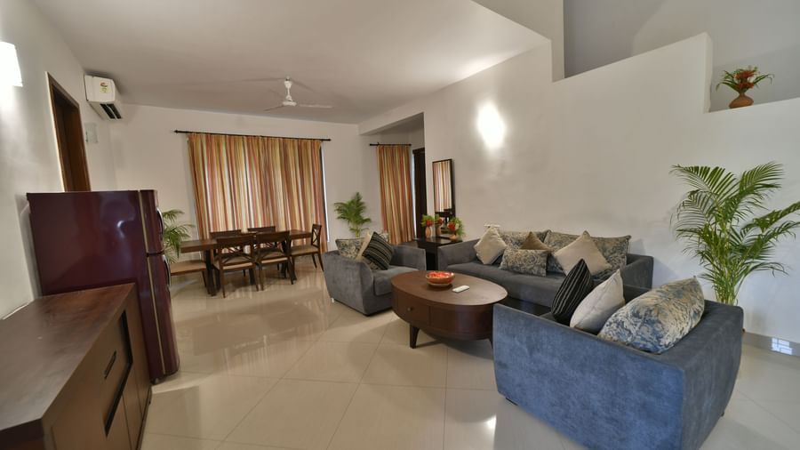 A wide shot of the interior living room, showcasing the seating arrangement and decor | Aqua Bungalow | Vedic Village Spa Resort, Kolkata