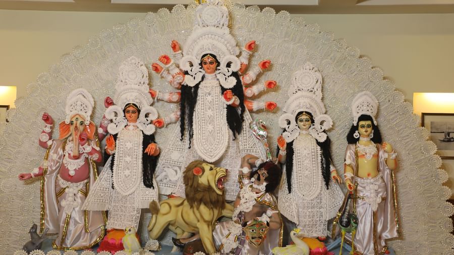 A wide shot of a large, intricately decorated idol of the Hindu goddess Durga with various deities | Vedic Village Spa Resort, Kolkata