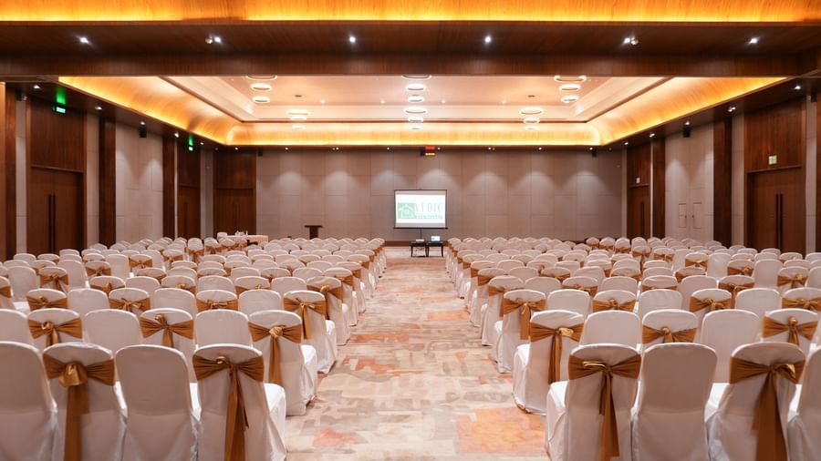 Utsav Convention Centre with classroom-style seating and a presentation screen at Vedic Village Spa Resort.