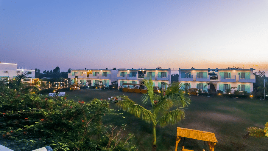 An evening view of Vedikant Resorts The Mallard Corbett displays multiple buildings and the surrounding environment at twilight.