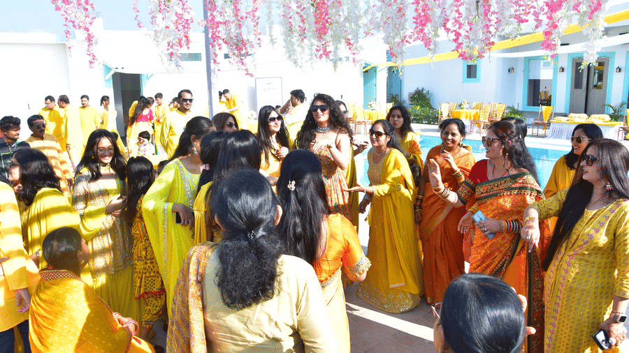 Family and friends enjoying the haldi rituals in a lively setting at Vedikant Resorts The Mallard Corbett.