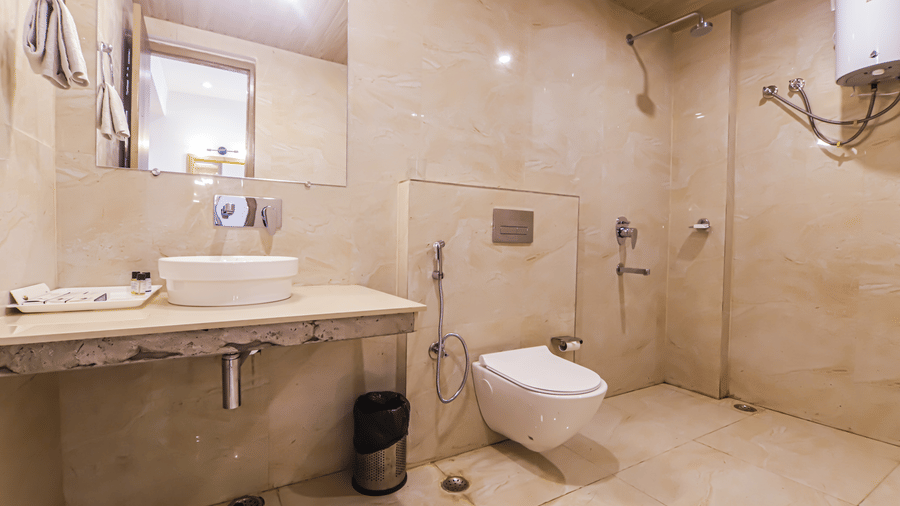 A bathroom at Vedikant Resorts The Mallard Corbett includes a sink, toilet, and shower area.