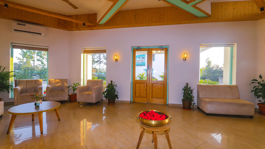 A cosy lounge at Vedikant Resorts The Mallard Corbett offers comfortable seating and a relaxed atmosphere.
