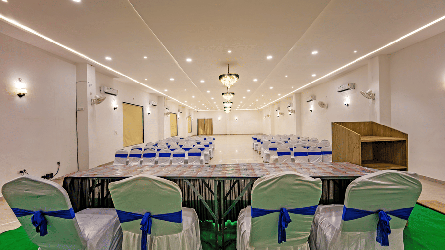 Mystic Jungle Hall at Vedikant Resorts The Mallard Corbett featuring a conference type setup with panels and podium in the stage and an arrangement of chairs for the crowd.