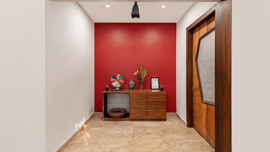 A hallway with a cabinet against a wall, decorations, and a door on the right - Via Lakhela Resort & Spa, Kumbhalgarh