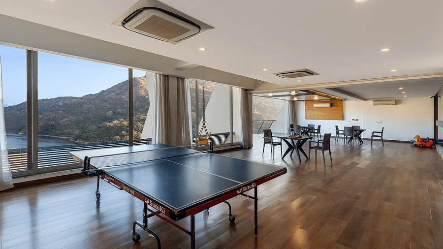 A hall with tennis table and large windows with a view - Via Lakhela Resort & Spa