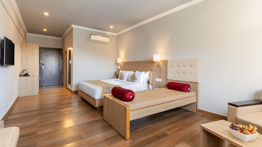 A room with a bed neatly arranged with a white cloth and pillows o it - Via Lakhela Resort & Spa, Kumbhalgarh