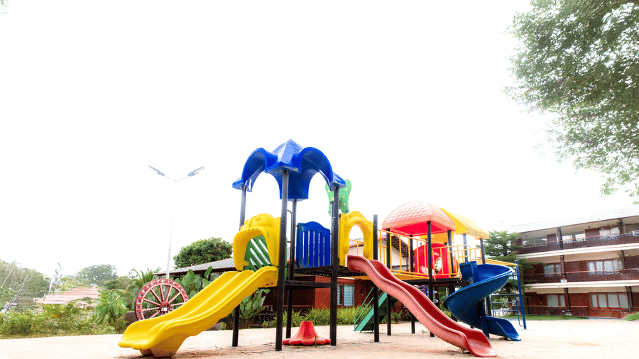 A children's outdoor playground featuring colorful plastic slides and climbing frames | Vintage Trails By Ilara