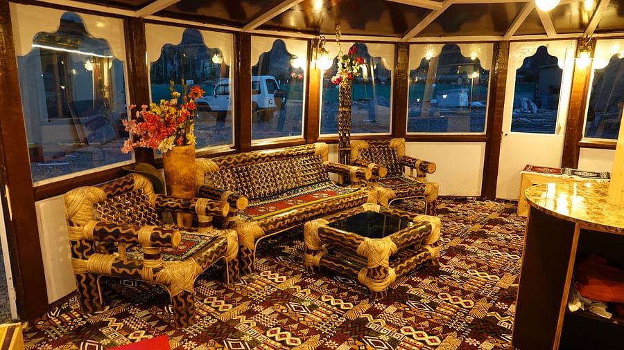 An interior featuring a wooden structure and large arched windows offering outdoor views at White Sands Resort, Ladakh.